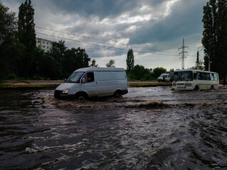 Cars on flooded road, disaster at city