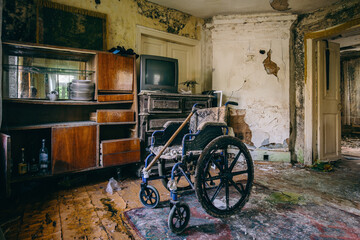 Empty wheelchair in old abandoned house
