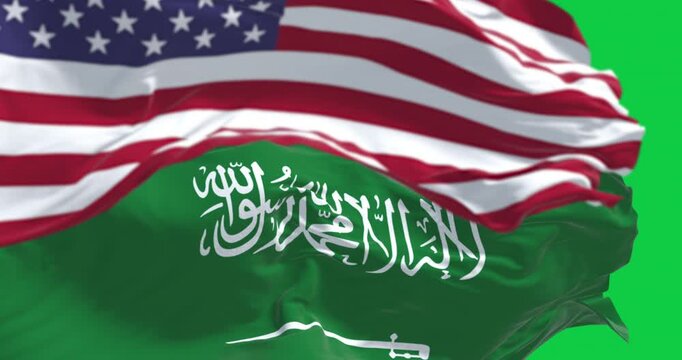 Saudi Arabian and American flags waving together isolated on green background