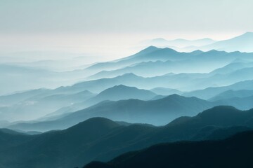 Naklejka premium Misty blue mountain layers under morning fog creating a serene landscape.