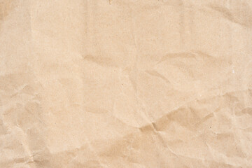 Crumpled brown kraft paper with visible creases and natural texture, isolated on a plain background. Suitable for design projects, packaging mockups, or backgrounds