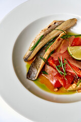 A Delightful Presentation of Elegant Fish Dish Accompanied by Fresh Vegetables and Garnishes, Showcasing Culinary Artistry and Flavor Harmony