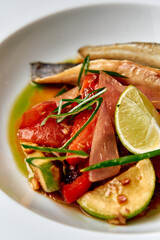 A Vibrant Dish Featuring Fresh Fish Garnished with Zesty Lime, Seasonal Vegetables, and Aromatic Herbs for a Flavorful Culinary Experience