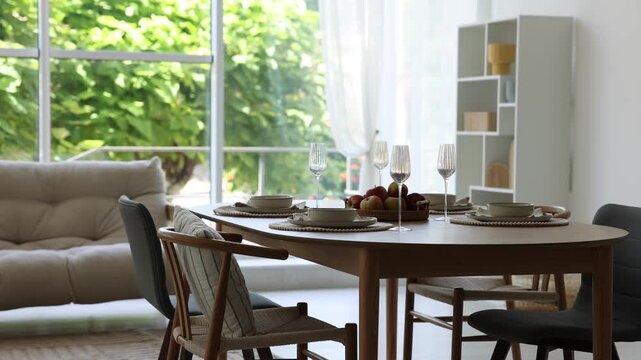 Beautiful table setting, chairs and decor in dining room. Camera moving down
