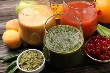 Superfood. Tasty smoothies in glasses and ingredients on wooden table, closeup