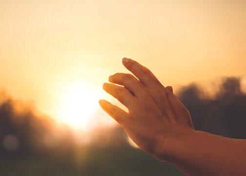 Hope. Woman reaching out her hand toward sun outdoors, closeup - Powered by Adobe