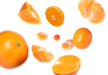 Juicy tangerines swirling in air against white background