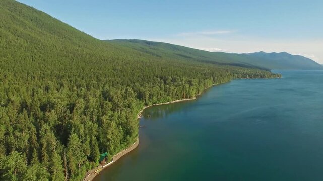 Aerial view of flathead lake surrounded by forest and mountains