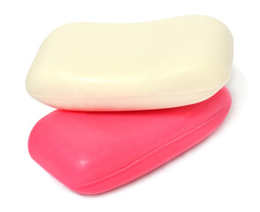 Two bars of white and pink soap isolated on white background