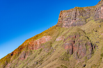 Stunning geological formation of a rugged mountain cliff, showcasing natural erosion and vibrant colors.
