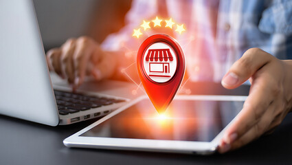 Person using laptop and tablet with store location pin and stars for online business concept