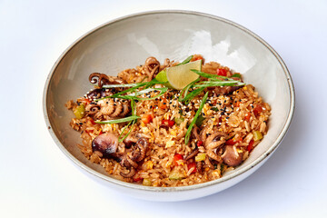 Deliciously Prepared Fried Rice with Tender Octopus, Colorful Vegetables, and Aromatic Herbs Served in a Charming Bowl