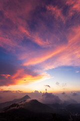 sunset with clouds,  over the mountains