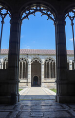 View of ornamental arches and courtyard hallway at the Pisa Cemetery (Camposanto Monumentale) in Pisa Italy.