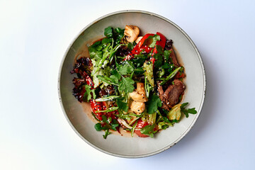 A Colorful Medley of Fresh Greens and Savory Ingredients: A Gourmet Salad Featuring Tender Meat, Vibrant Vegetables, and Flavorful Dressing in a Stylish Bowl