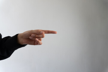 Business person's hand pointing towards a gray gradient background