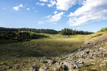 Scenic Mountain Landscape in Peter Sinks, Utah – Alpine Meadows, Rocky Hills, and Pine Forest Under a Blue Sky