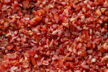 Chopped fresh cubes sliced red tomatoes on top view