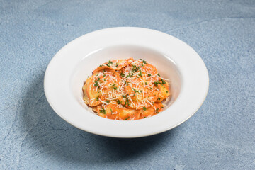 A plate of delicious cheesy ravioli in vodka sauce.