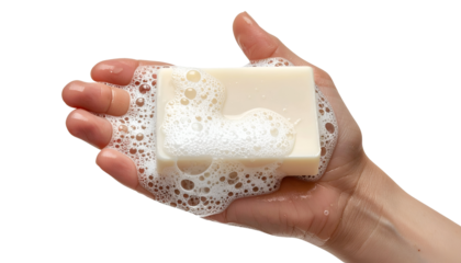 Bar of creamy white soap with thick foam and bubbles held in hand on isolated background