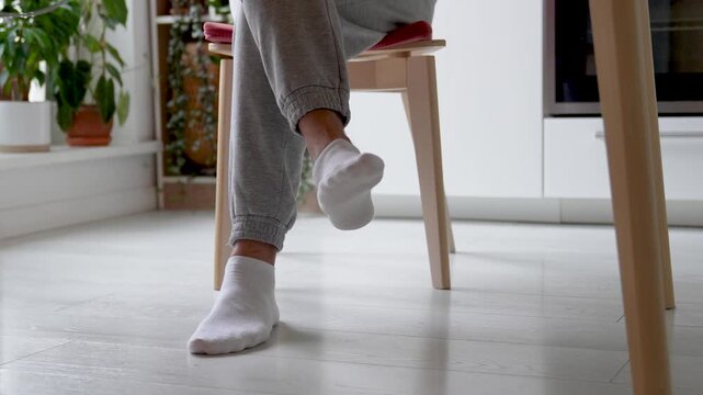 Restless feet tapping nervously legs scraping chair twitching involuntarily. ADHD symptoms, hyperactive stim, leg cramps or muscular spasm physical tension, hyperactive traits, stress response