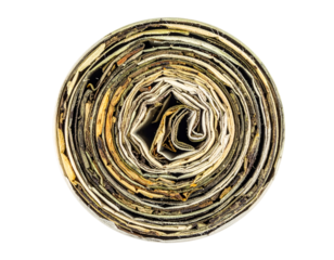 Rolled dried herbal tea leaves compressed in circular shape for brewing on isolated background