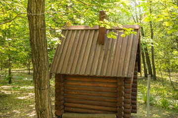 Vintage installation in the park. A small log cabin fairy tale house