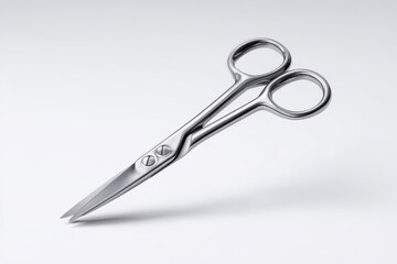 Sharp silver metal scissors on a light gray background