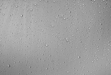 Rainy Glass Close-up.A clear, detailed capture of rain-like water droplets forming on a flat surface. The fine detail and uniform distribution make it perfect for use in scientific visuals or as a pho