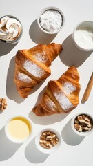 Elevated flat lay of croissants with powdered sugar and dipping elements