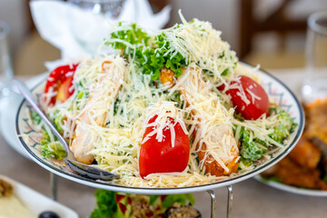 Caesar salad with croutons, cheese, eggs, tomatoes and grilled chicken. Food