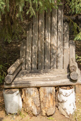 Park installation of a wooden sculptural chair made of logs