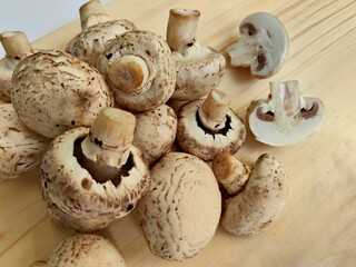 Pile of Fresh Cremini Mushrooms on Wood
