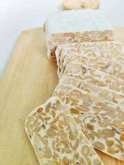Freshly Sliced Tempeh on a Wooden Cutting Board