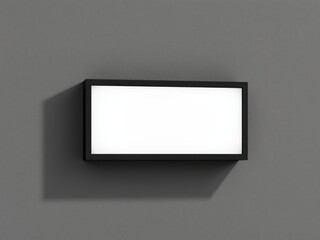A rectangular white blank illuminated sign with a black frame mounted on a gray textured wall
