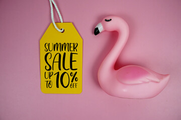 Price tag Sale 10% with pink flamingo summer decorations on pink background