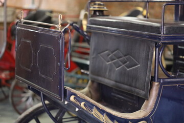 A horse-drawn carriage sitting indoors, useful for scenes about luxury, elegance, and nostalgia