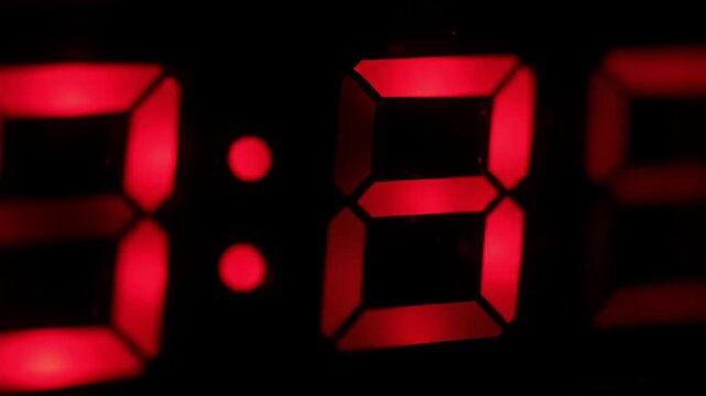 Red digital clock showing 808, dark background, time lapse
