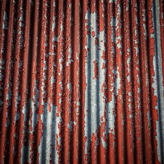 Weathered Red Corrugated Metal Background with Peeling Paint Texture
