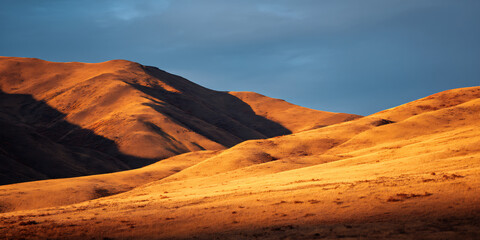 hilly terrain shadows dramatic sunlight nature afternoon