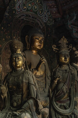 Brass painted Buddha Statue in ancient temple in Shanxi China
