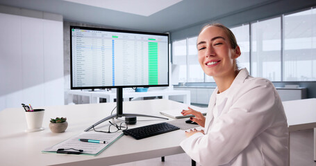 Female Healthcare Analyst Utilizing Hospital Invoice Coding Spreadsheet Online