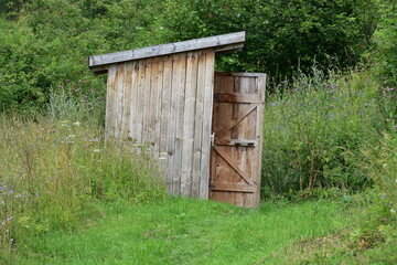 old wooden outhouse toilet bathroom door