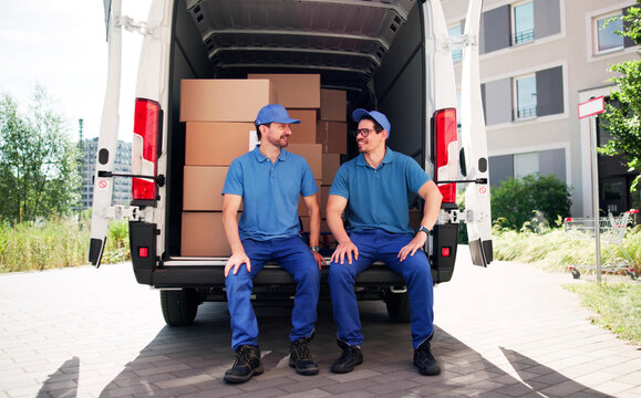 Hardworking Team Of Movers Delivering Efficient Furniture Moving