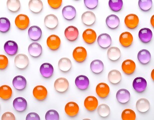 Translucent colored hydrogel balls arranged on a plain white surface flat lay style
