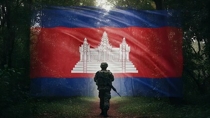 A soldier stands in a dense jungle, facing the national flag of Cambodia. Suitable for content on military themes, national pride, history, or armed forces.