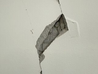 Cement wall crack and break at ceiling to wall from earthquake