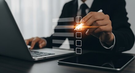 Businessman Completing Checklist on Digital Interface with Laptop and Tablet Prioritizing Tasks for Efficient Workflow and Project Management in a Modern Office Setting
