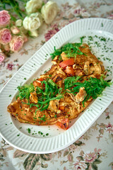 Delicious and Colorful Omelette Garnished with Fresh Vegetables and Herbs Served on a Decorative Plate Among Beautiful Roses