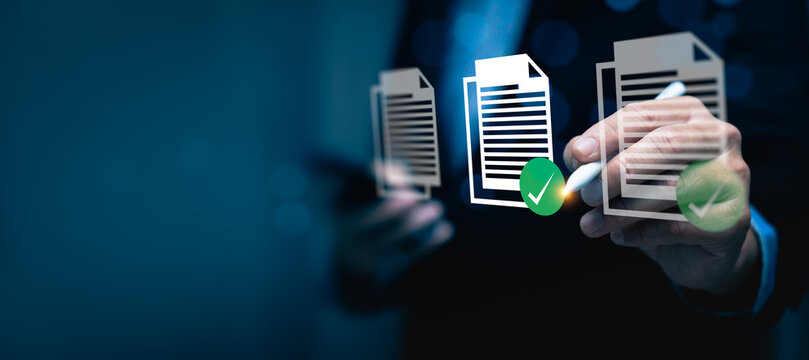 Businessman using digital pen to approve virtual document icons with green check marks, representing online document verification, digital signature, data approval workflow, electronic documentation